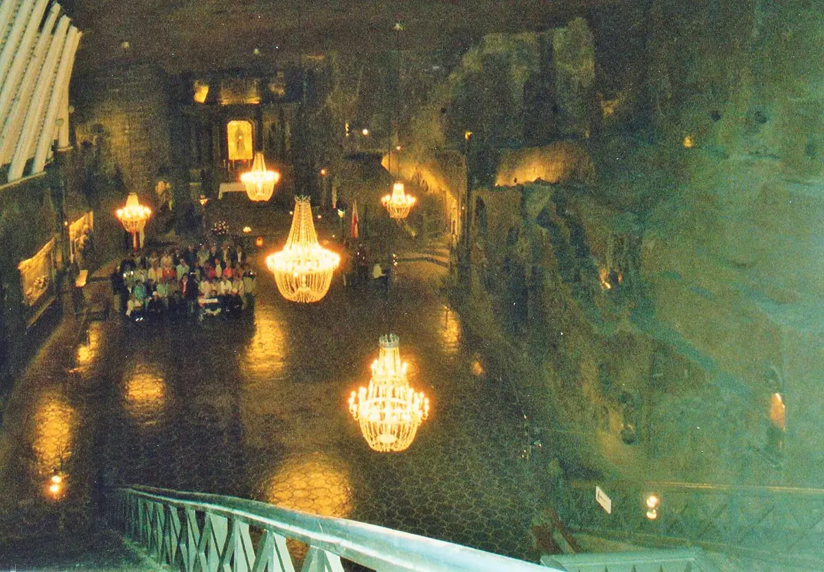 A chamber lit by chandeliers deep underground